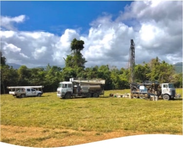 Ingham Drilling's branded trucks and a bore drilling truck are ready to drill a water bore in Cairns QLD
