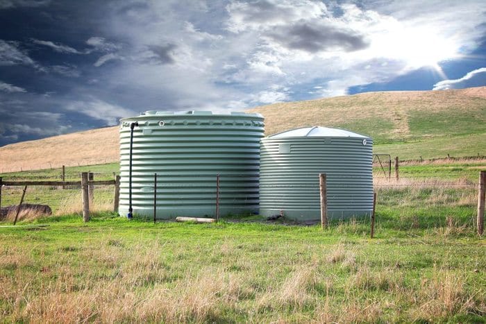 two eco friendly water tanks with rains storm