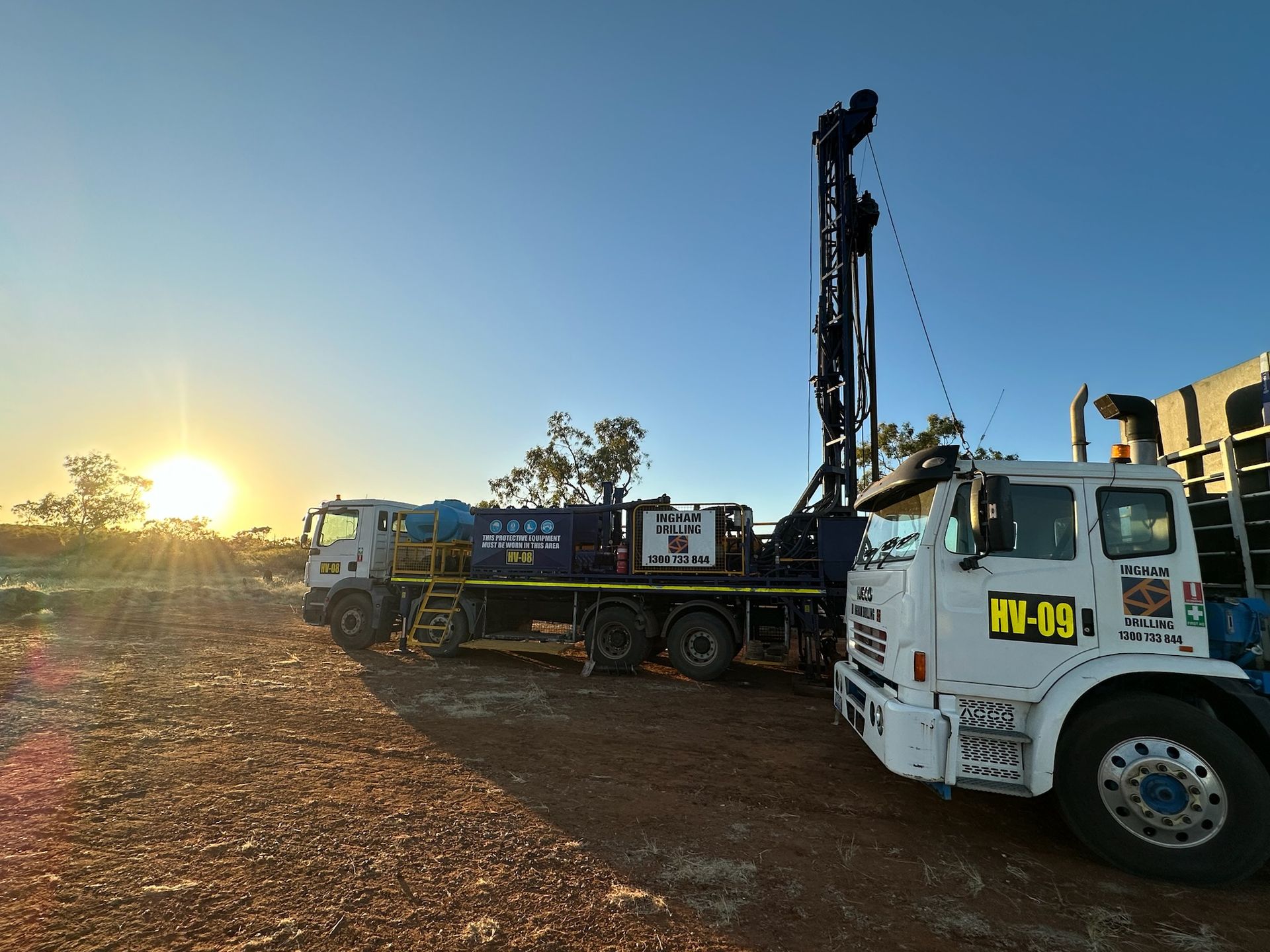 MAN rig HV-08 and Iveco support truck HV-09 at sunrise on red dirt