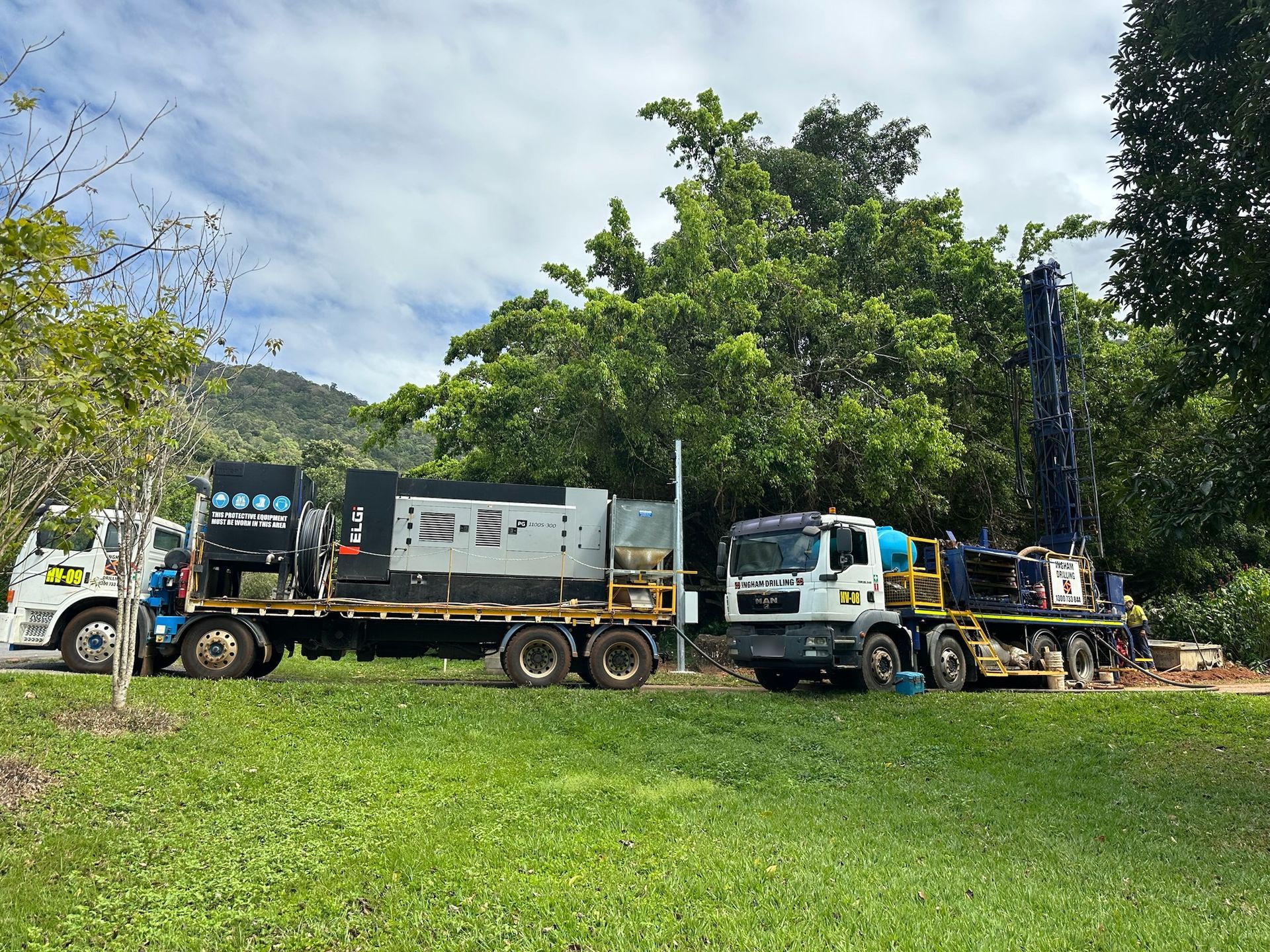 Ingham Drilling rig and compressor truck set up on a grassed site