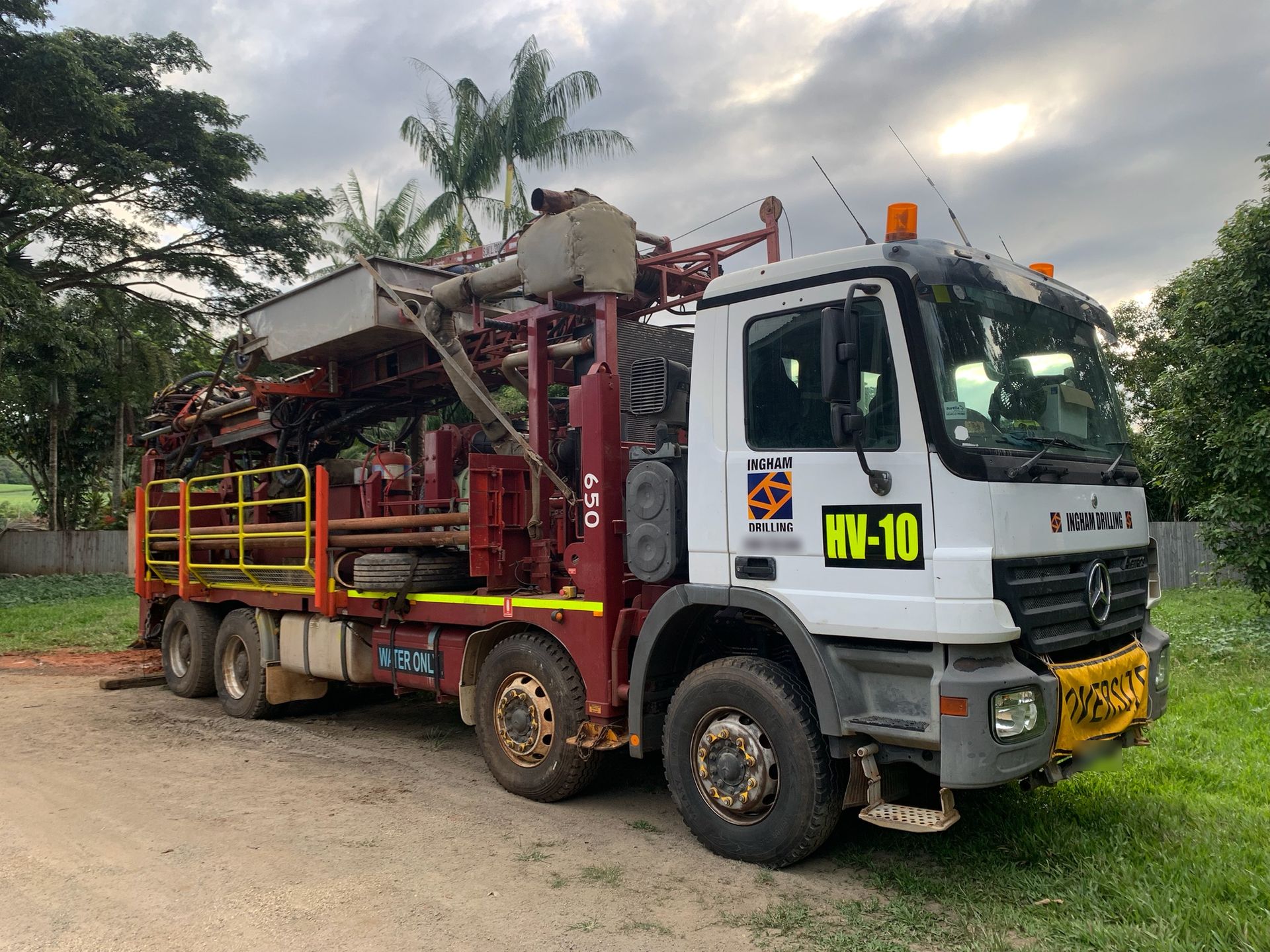 Red UDR650 drill rig HV-10 on a white Mercedes-Benz Actros truck
